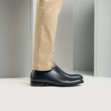 Styled Fit Perspective of Director Wholecut Midnight Blue Leather Shoes For Men on Model - Natural Daylight Drape